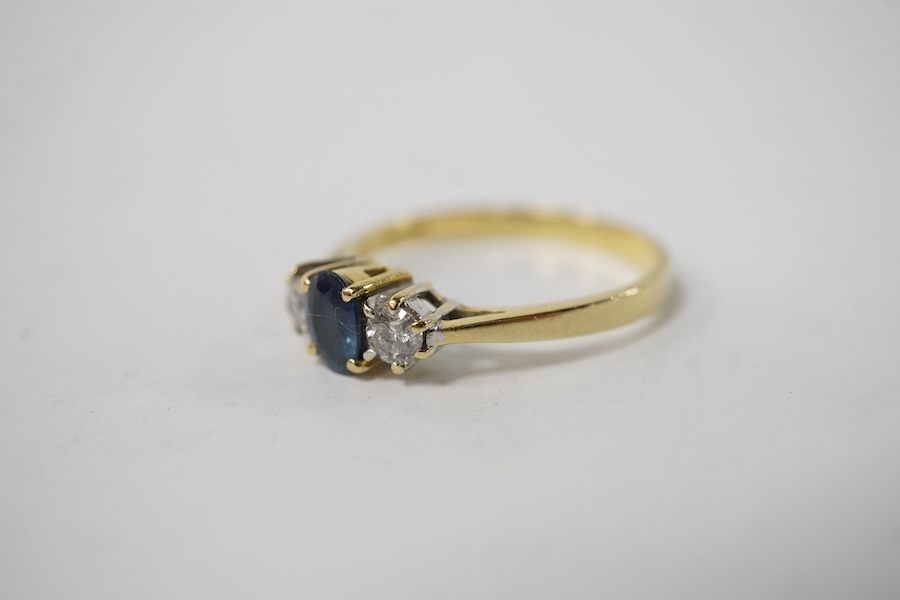 A modern 18ct gold, single stone sapphire and two stone diamond set ring, size Q, gross weight 3 grams. Condition - poor to fair